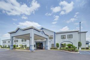 a large white building with a parking lot at Best Western Opp Inn in Opp