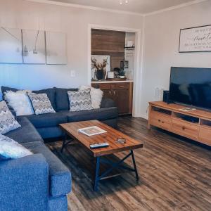 a living room with a blue couch and a coffee table at Beechview Condo in Beech Mountain