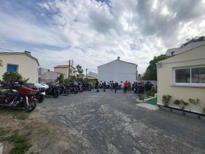 a group of motorcycles parked on the side of a street at Hotel Les Rosiers in La Rochelle +16 photos