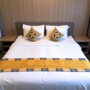 a large white bed with two pillows on it at Sewwandi Guest House in Arugam Bay
