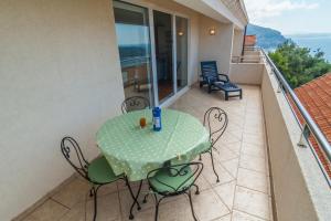 a table and chairs on the balcony of a house at Apartments Simic in Dubrovnik