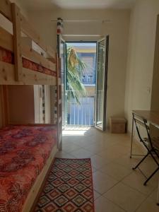 Schlafzimmer mit Etagenbett und Balkon in der Unterkunft Casa vacanze Nonna Anna in Montesilvano