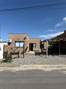 a house with a bench on the side of the street at Pintó-apart in Cafayate