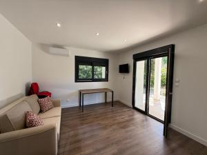 a living room with a couch and a table at Montelimar Location in Montélimar