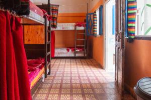 a room with two bunk beds and a hallway at The Chill Art Hostel in Essaouira