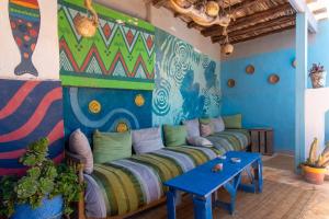 a living room with a couch and a table at The Chill Art Hostel in Essaouira