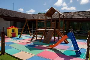 a playground with a slide and a swing set at Resort beira-mar Porto Galinhas in Porto De Galinhas