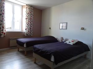 a bedroom with two beds and a window at Gîte authentique avec terrasse, jardin, proche thermes et nature - FR-1-589-212 in Senaide