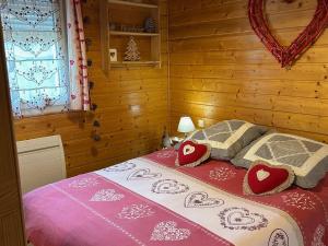 a bedroom with a bed with red and white pillows at Appartement avec Terrasse & Piscine Privée, Gérardmer - FR-1-589-56 in Gérardmer +26 photos