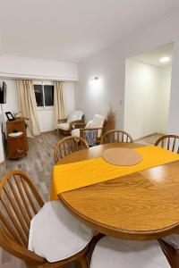 a living room with a wooden table and chairs at Rincón del mar in Mar del Plata