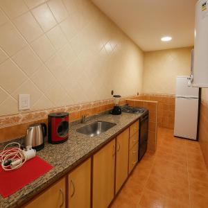 a small kitchen with a sink and a refrigerator at Rincón del mar in Mar del Plata