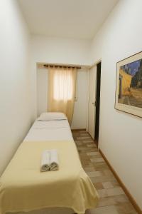 two beds in a room with two towels on them at Rincón del mar in Mar del Plata +1 photo