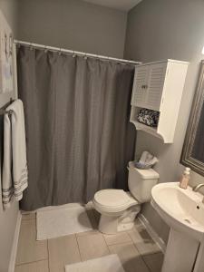 a bathroom with a toilet and a sink at Welcome to Luigi! in Omaha +7 photos