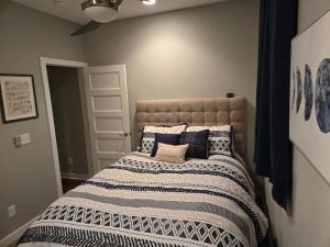 a bedroom with a large bed with pillows on it at Welcome to Luigi! in Omaha