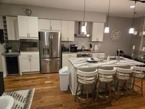 a kitchen with a large island with bar stools at Welcome to Luigi! in Omaha