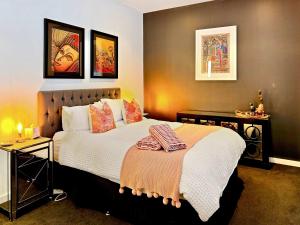 a bedroom with a bed with two pillows on it at Luxury 2-Bedroom Townhouse in Adelaide CBD in Adelaide