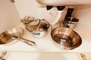 a kitchen counter with pots and pans on it at Seu Cantinho aconchegante Wi-Fi turbo e Netflix – Salvador in Salvador +29 photos