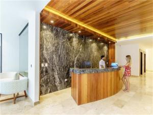 a man and a woman standing at a bar at Serenada Boutique Room Near 5th Ave in Playa del Carmen +20 photos