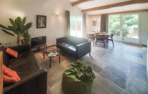 a living room with a couch and a table at 3 Bedroom Stunning Home In Vieussan in Vieussan