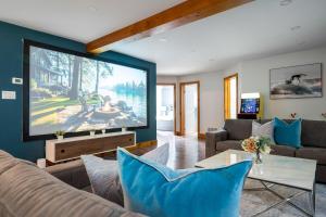 a living room with a large flat screen tv at 10 Br with Large Hot tubs 130 Proj Screen FirePit in Blue Mountains