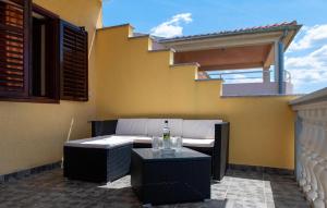 a patio with a table and chairs and a building at Two-Bedroom Apartment In Sibenik in Šibenik