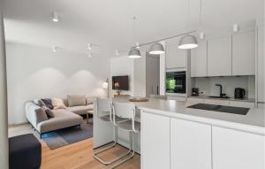 a kitchen and living room with white cabinets at 1 Bedroom Amazing Apartment In Tossens in Stick