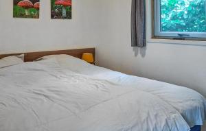 a white bed in a bedroom with a window at 2 Bedroom Lovely StaCaravan In Vorden in Vorden +3 photos