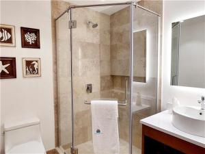 a bathroom with a shower and a toilet and a sink at Serenada Boutique Room Near 5th Ave in Playa del Carmen