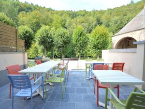 a patio with tables and colorful chairs and trees at Holiday Home in Bouillon with Terrace in Bouillon