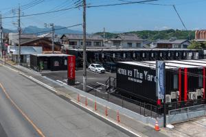 an empty street with a car driving down a road at HOTEL R9 The Yard Tomiokananokaichi in Tomioka +16 photos