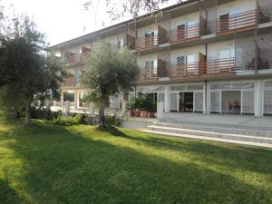 an apartment building with a lawn in front of it at Elaia Garden Hotel in Sperlonga