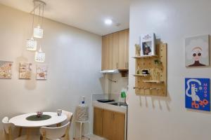 a kitchen with a small table and a small kitchen with a table at Tiny's BnB in Davao City