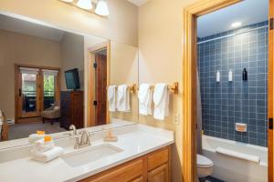 a bathroom with a sink and a mirror at Cimarron Lodge 35 condo in Telluride