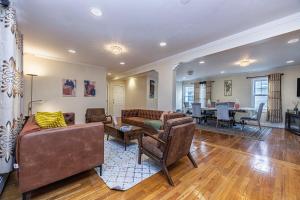 a living room with couches and a dining room at Extremely Spacious Home 10 Mins to The Encore in Medford