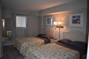 a hotel room with two beds and a window at Gorgeous Oceanfront 3 Bedrooms Condo Sleeps up to10 people - Initial supply of Linens Included in Myrtle Beach