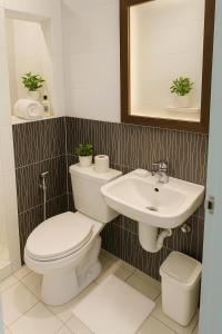a bathroom with a toilet and a sink at Queen room only near sm mall Fast Wifi in Malabañas
