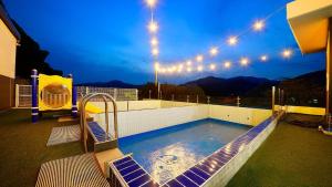 a swimming pool on top of a building with lights at Gapyeong Eco Healing Pool Villa Pension in Gapyeong