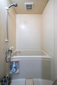 a bathroom with a tub and a shower at Silk Court 405 in Chitose