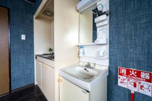a bathroom with a sink in a room at Silk Court 405 in Chitose