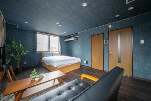 a bedroom with a bed and a couch and a table at Silk Court 405 in Chitose +68 photos