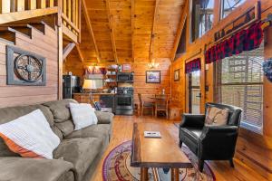 a living room with a couch and a table at Cozy Mountain Cabin Getaway with Hot Tub for 4 Guests in Pigeon Forge +18 photos
