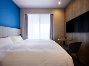 ES CON FIELD HOKKAIDO HOTEL Kitahiroshima Station客房内的一张或多张床位