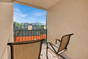two chairs sitting on a balcony with a view at Trendy 2 BDR Condo with Pool & Hot Tub Near Downtown in Gatlinburg