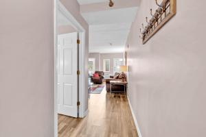 a hallway with a white door and a living room at Trendy 2 BDR Condo with Pool & Hot Tub Near Downtown in Gatlinburg