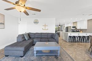 a living room with a couch and a ceiling fan at Waterfront Escape 3BR Townhome Pet-Friendly Sleeps 8 in Marietta