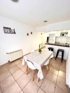 a kitchen with a table and chairs in a room at Departamentos Echeverria in Río Gallegos