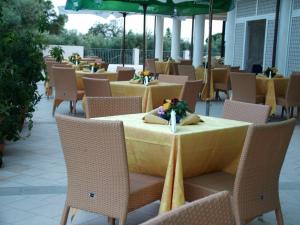a restaurant with tables and chairs with a yellow table cloth at Elaia Garden Hotel in Sperlonga