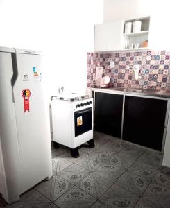 a kitchen with a white refrigerator and a stove at Ap espaçoso prox aeroporto in Manaus