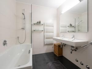 ein weißes Badezimmer mit Waschbecken und Dusche in der Unterkunft Alpine Apartment near Kaprun, cleaning included in Dürnberg