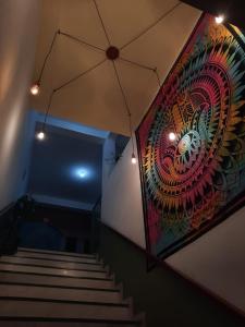 a staircase with a painting on the wall and a mural at Pousada Silva Guedes in São Thomé das Letras
